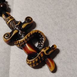 Gothic Style Snake And Sword Pendant Necklace, Crafted From Resin To Mimic Carved Bone Or Coconut Shell(NM)