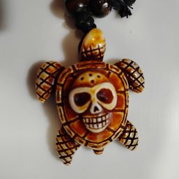 Hawaiian-style Sea Turtle Pendant Necklace Features A Carved Skull Design On The Shell And Made In China  (NM)