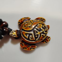 Unisex Resin Turtle Pendant Necklace Features Tribal Or Hawaiian-inspired Carvings (NM)