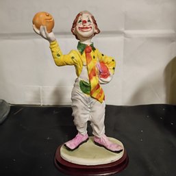 Vintage Clown Figurine, Specifically A Hobo Clown Holding An Orange And Standing On A Wooden Base (NM)