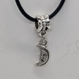 Silver-toned Charm Necklace Featuring A Smiling Crescent Moon Pendant On A Black Cord (NM)