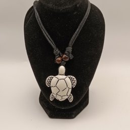 White Resin Carved Tribal Style Sea Turtle Pendant On A Black Adjustable Cord Necklace With Wooden Beads (NM)