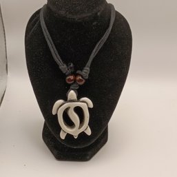White Resin Carved Tribal Style Sea Turtle Pendant On A Black Adjustable Cord Necklace With Wooden Beads (NM)