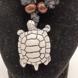 White Resin Carved Tribal Style Sea Turtle Pendant On A Black Adjustable Cord Necklace With Wooden Beads (NM)