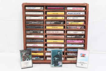 Collection Of Cassette Tapes In A Wooden Storage Rack