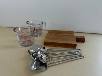 Selection Of Kitchen Items - Cutting Board, Measuring Cups & Utensils