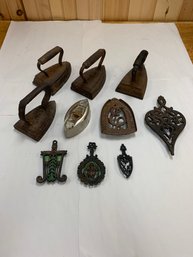 LOT OF 10 TRIVETS AND IRONS