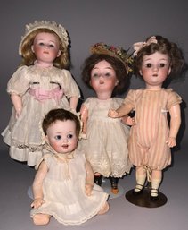 4 Small Bisque Head Dolls