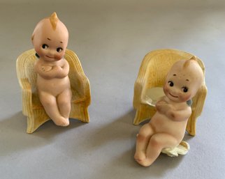 2 - 3  Kewpies Seated In A Yellow Chair With Crossed Arms