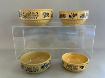 Four Yellowware Bowls That Feature A Decorative Band With A Blue Pattern
