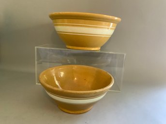 Two Pieces Of Yellowware Mixing Bowls With A White Banded Design