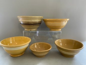 Five Pieces Varying Banded Yellowware Bowls.