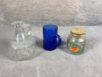 Group Of Three Vintage Glass Items, Pitcher, Blue Mug, And Cork-topped Jar