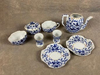 Flow Blue And White Floral Porcelain Tea Set, Teapot, Sugar Bowl, Cup, Saucers, And Egg Cups