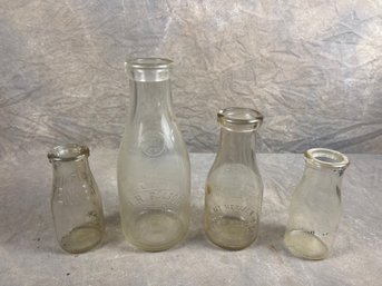 Group Of Four Embossed Glass Milk Bottles